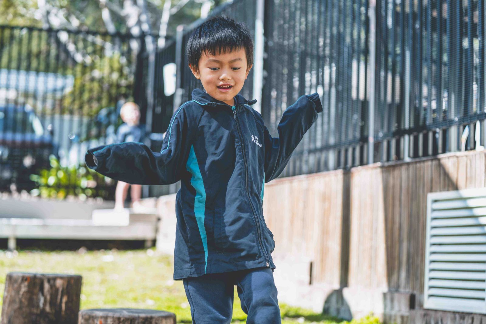 Student balancing and playing outdoors in school playground